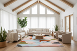 A bright, modern living room with a large abstract area rug as the focal point, surrounded by a beige sofa, two armchairs, a round wooden coffee table, and potted plants under a high ceiling with exposed wood beams.
