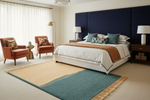 Modern bedroom with a bed, chairs, and decorative elements.