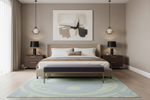 Modern bedroom with a bed, nightstands, and abstract art on the wall.