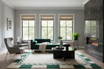 Modern living room with green sofa, gray chairs, and a fireplace.