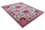 Floral patterned rug with pink flowers on a gray background