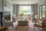 Living room with pink rug, gray sofa, armchairs, and a coffee table.