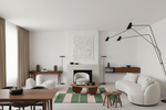 Modern living room with white furniture, a colorful rug, and minimal decor.