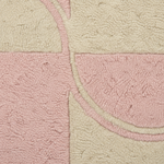 A close-up of a textured, looped pile rug featuring a geometric pattern in soft pink and cream.