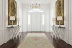 Elegant interior with white walls, a chandelier, and decorative rugs.