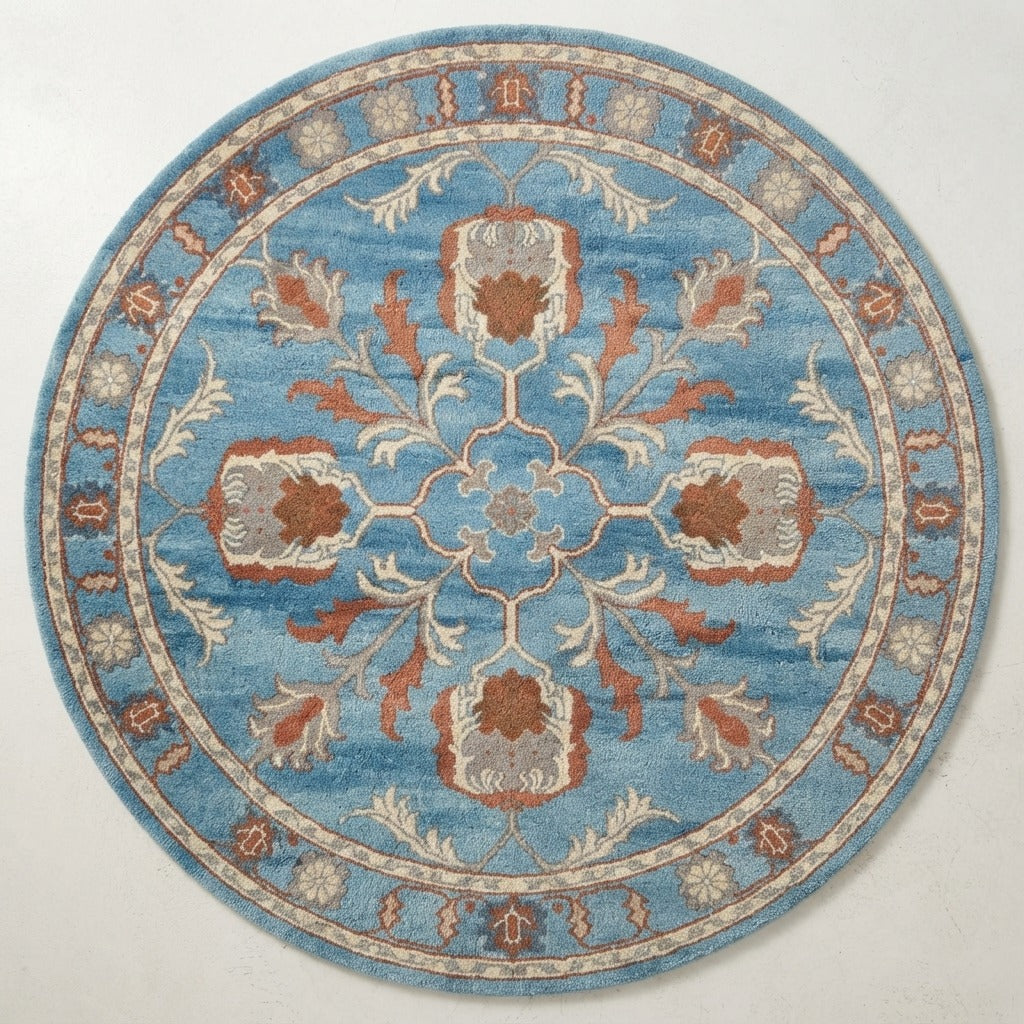 Cerulean Pomegranate Wheel Round Hand Tufted Wool Rug - studio photo