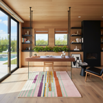 Modern home office with wooden desk, shelves, and colorful rug.