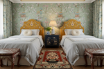 Two beds with floral headboards in a room with decorative wallpaper and red chinoiserie rug.