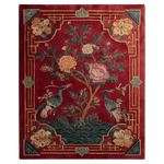 Decorative rug with floral and bird patterns on a red background