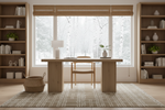 Modern home office with wooden desk, chair, neutral handmade rug, and bookshelves.