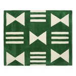 A square green rug with a cream geometric pattern of bows, stripes, and triangles, shown flat against a white background.