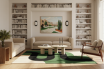 Modern living room with beige sofa, bookshelves, green contemporary rug, and a painting on the wall.