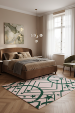 A styled bedroom interior featuring a brown upholstered bed with beige bedding, a large abstract wall painting, a green accent chair, and a light pink rug with a dark green geometric star pattern on a wood floor.