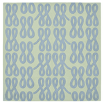 Pattern of blue interlocking shapes on a green rug