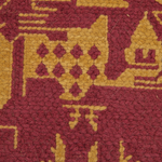Close-up of a textured woven rug with a geometric castle pattern in deep burgundy and mustard yellow.