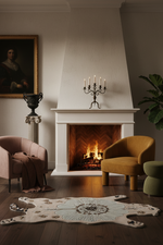 Cozy living room with a fireplace, chairs, and decorative bear rug.