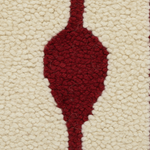 Close-up of a textured area rug featuring a deep burgundy red teardrop motif on a warm cream background.