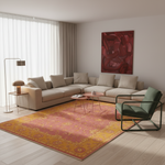 A styled living room featuring a large area rug with a distressed pink and yellow floral pattern, a beige sectional sofa, a green armchair, and a large red abstract painting on the wall.
