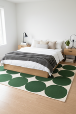 Modern bedroom with a bed, nightstands, and a green circular rug.