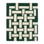 Green and white geometric patterned rug on a white background