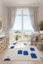 Modern nursery room with a large window, white sofa, and blue decorative bags on a rug.