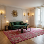 A luxurious living room featuring a deep green velvet sofa, a large pink and gold patterned area rug, and elegant wall decor in a classic Parisian-style apartment.