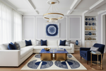 Modern living room with white sofa, blue accents, and decorative blue contemporay rug.