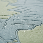 Close-up of a textured fabric surface with embossed leaf-like patterns in muted blue-gray and pale sage green, covered with small water droplets.