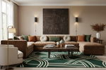 A styled living room featuring a large brown sectional sofa with green and orange accent pillows, a dark wood coffee table, a green and cream patterned rug, and a large textured dark brown wall art piece centered on a beige wall.