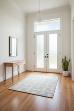 Modern interior with a rug, console table, and French doors.