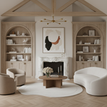 Modern living room with wooden shelves, a fireplace, organic shaped white rug, and a chandelier.