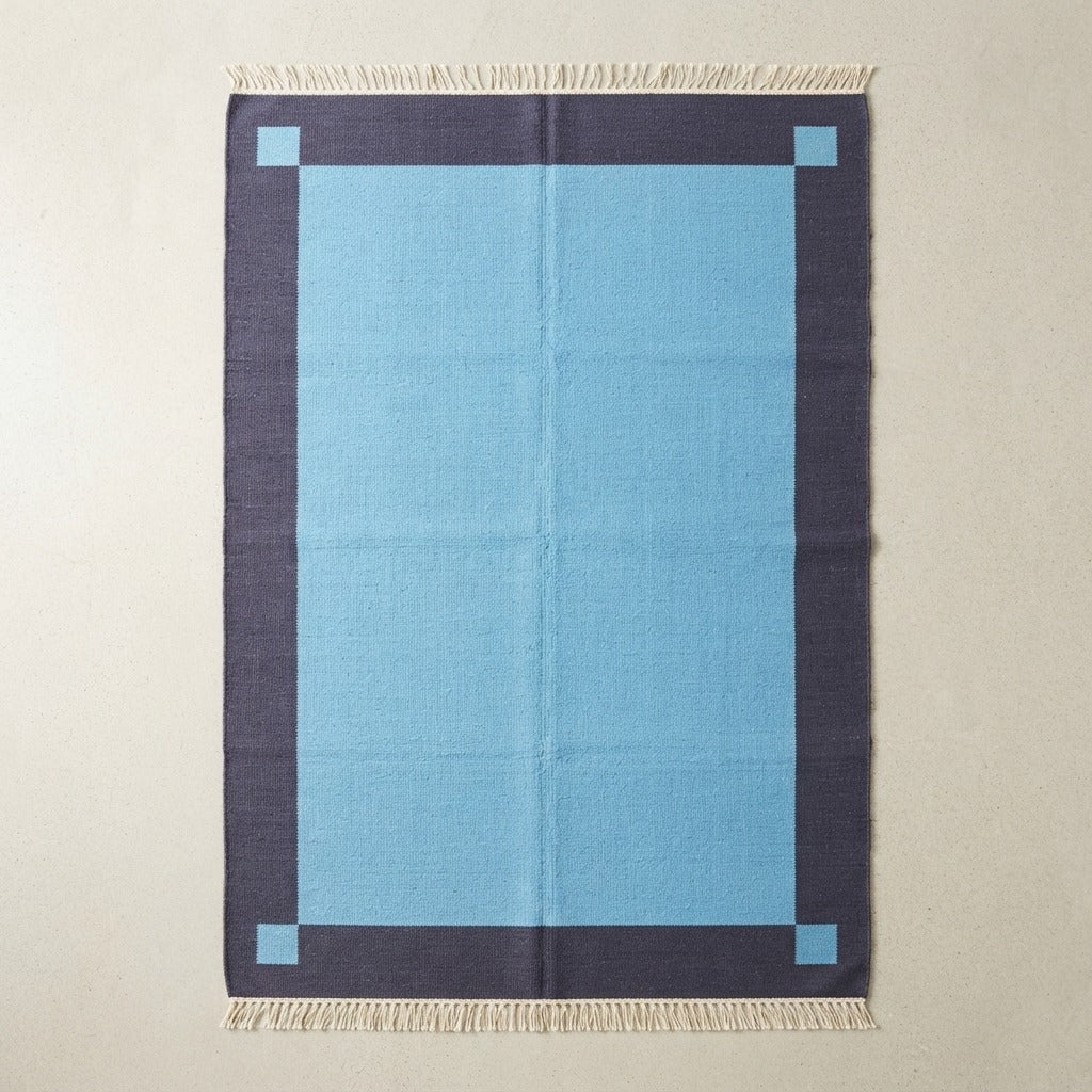Lagoon Frame Flatweave Cotton Dhurrie Rug - studio photo