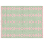 A rectangular woven rug with a sage green background and a repeating light pink geometric pattern, featuring pink fringe on the left and right edges.