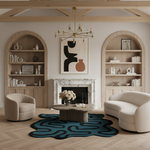 Modern living room with a fireplace, bookshelves, and a blue and black organic shape rug.