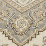 Close-up of an ornate patterned rug with a traditional medallion design in cream, beige, taupe, and light gray tones.