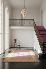 Staircase with a pink runner in a well-lit room with large windows.