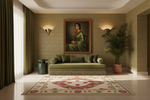 A styled interior room with a large framed portrait of a woman in a green dress hanging above an olive green sofa. The room has textured beige walls, warm wall sconces, a patterned rug, a potted palm, and dark green curtains.