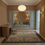 A beautifully styled interior room with light wood paneling, a large patterned area rug, a round white pendant light, and a built-in daybed with striped cushions in the background.