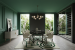 Modern dining room with green and beige contemporary rug, green walls, a chandelier, and a large window.