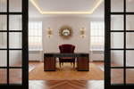 Modern office interior with a desk, chair, and decorative rug.