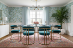 Dining room with a table and chairs in a stylishly decorated room with traditional pink knotted rug