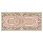 A rectangular area rug with a traditional geometric pattern in dusty pink, beige, and taupe brown, shown flat against a white background.