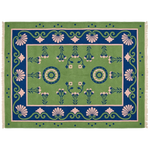 A rectangular woven rug with a green field, blue border, and pink floral motifs, shown flat against a white background.