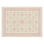 A rectangular area rug with a cream background, a dusty pink border, and a central medallion pattern in sage green, coral pink, and light blue.