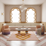 A luxury bohemian-style living room featuring a pink and gold geometric area rug, two blush pink armchairs with purple gradients, a cream curved bench, and two tall arched windows with gold frames.