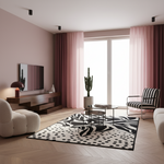 A modern living room with blush pink walls and curtains, light wood herringbone flooring, a black-and-white patterned rug, a wooden media console with a TV, a white boucle chair, a striped armchair, and a potted cactus near the window.