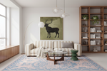 A modern living room featuring a large square wall art print of a black deer silhouette on an olive green background, hung above a cream and beige striped sofa.