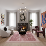 Modern living room with a pink art deco rug, white sofa, and abstract art on the walls.