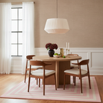 Dining room with wooden table and chairs on a pink rug