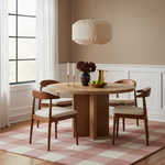Dining room with wooden table and chairs on a checkered rug